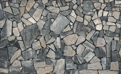 Texture of a stone. Old stone wall texture background. Grey stone wall as a b Stock Photos