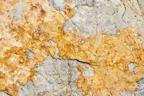 Texture of stone surface up close with grey and yellow colors Stockfoto's