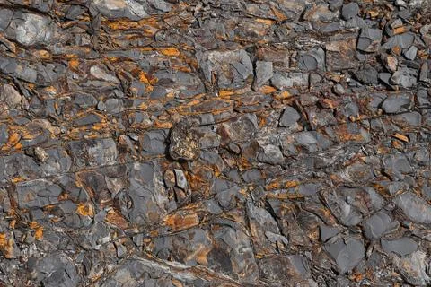 The texture of the stone surface of the mountain with minerals of different c Stock Photos