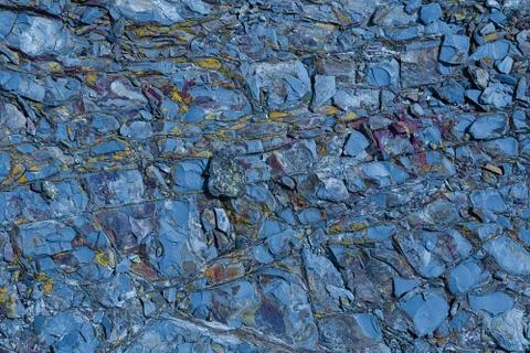 The texture of the stone surface of the mountain with minerals of different c Stock Photos