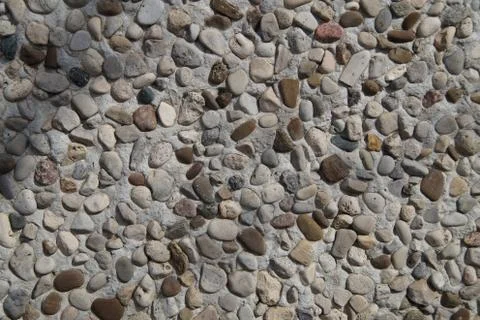 Texture of stone wall covered with pebbles Stock Photos
