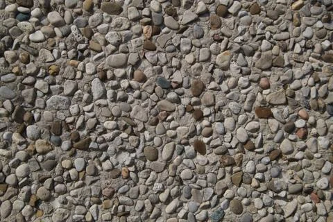 Texture of stone wall covered with pebbles Stock Photos