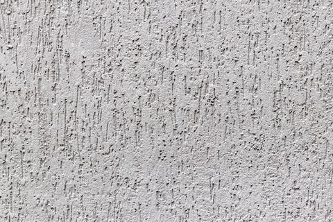 Texture of a stone wall with cracks and scratches which can be used as a backgr. Stock Photos