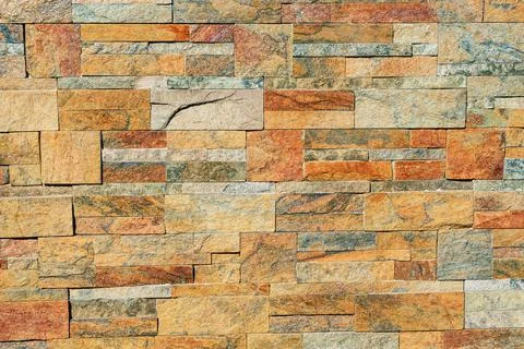 Texture of a stone wall. Earth coloured slate stone background. Stone texture Stock Photos