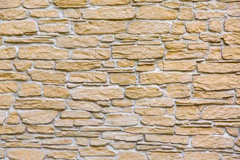 Texture of the stone wall of the facade of the building. Stock Photos