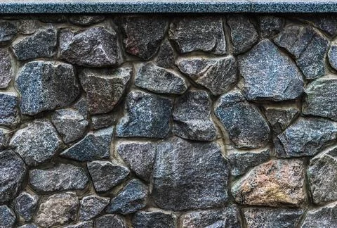 Texture of a stone wall, granite stone wall background, stacked pieces stones Stock Photos