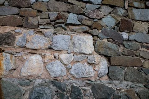 Texture of stone wall made of grey stones Stock Photos