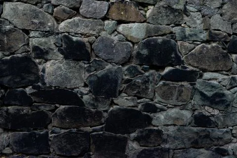 Texture of stone wall made of grey stones Stock Photos