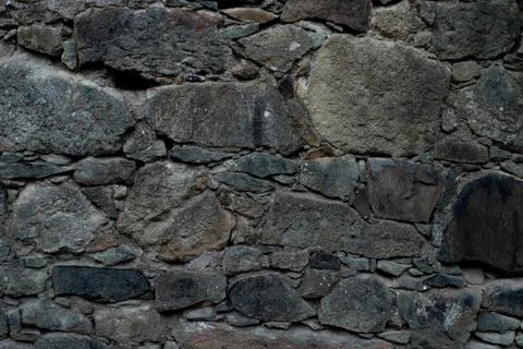 Texture of stone wall made of grey stones Stock Photos