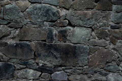 Texture of stone wall made of grey stones Stock Photos