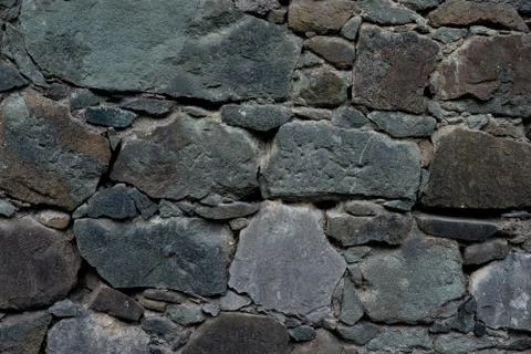 Texture of stone wall made of grey stones Stock Photos