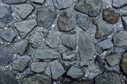 Texture of stone wall made of grey stones Stock Photos