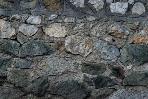 Texture of stone wall made of grey stones Stock Photos