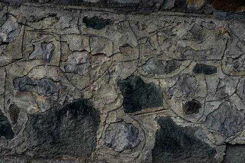 Texture of stone wall made of grey stones Stock Photos