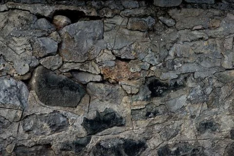 Texture of stone wall made of grey stones Stock Photos