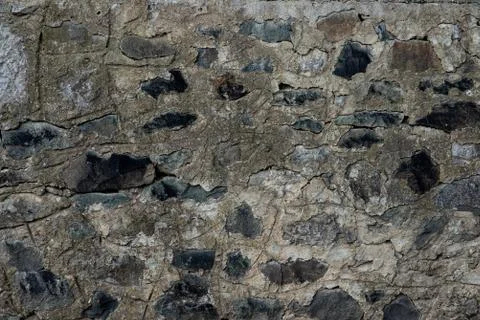 Texture of stone wall made of grey stones Stock Photos
