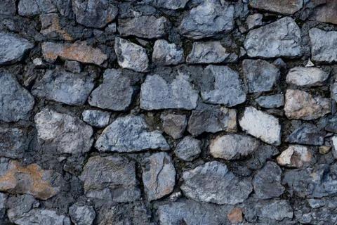 Texture of stone wall made of grey stones Stock Photos