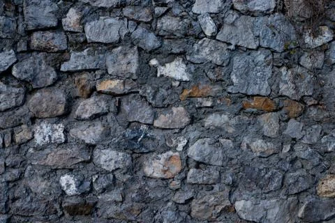 Texture of stone wall made of grey stones Stock Photos