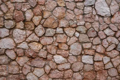 Texture of stone wall made of grey stones Stock Photos