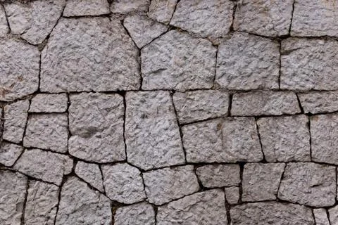 Texture of stone wall made of grey stones Stock Photos