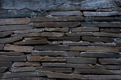 The texture of a stone wall made of rectangular strips Stock Photos