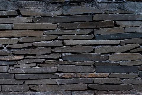 The texture of a stone wall made of rectangular strips 스톡 사진