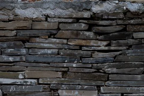 The texture of a stone wall made of rectangular strips Stock Photos
