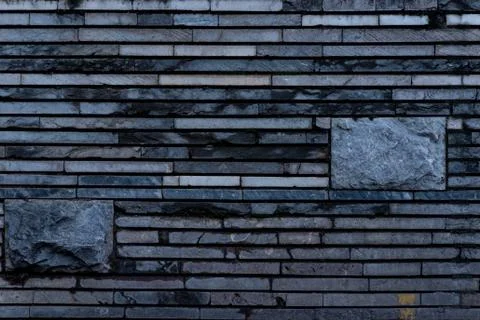 The texture of a stone wall made of rectangular strips Stock Photos