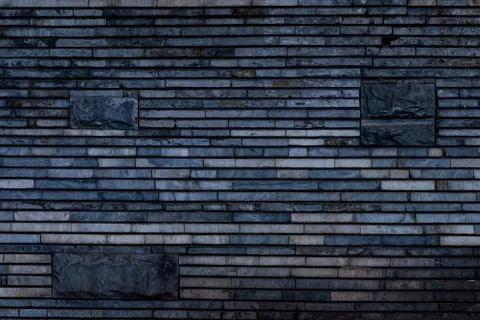The texture of a stone wall made of rectangular strips Stock Photos
