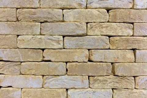 The texture of the stone wall of the old brick, building stone of beige-golde Fotos de archivo