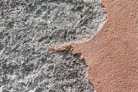 Texture of a stone wall of an old building with crumbling plaster, ancient ar Stock Photos