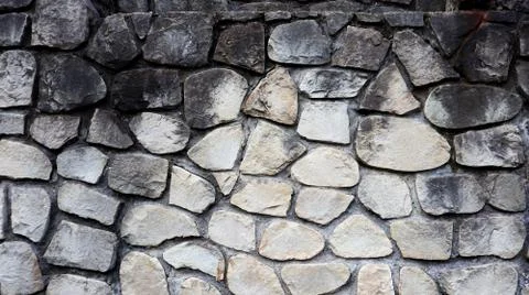 The texture of the stone wall. Old castle stone wall texture background. Stock Photos