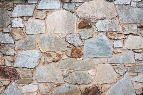 Texture of a stone wall. Old castle stone wall background. Wall made of wild  Stock Photos