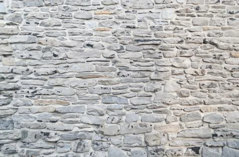 Texture of a stone wall. Old castle stone wall texture background. Part of a Stock Photos