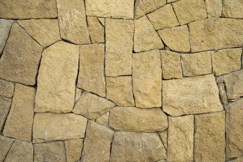 The texture of a stone wall. Old castle stone wall texture background. Stock Photos