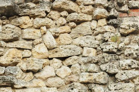 Texture of a stone wall. Old castle stone wall texture background. Stock Photos