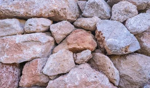 Texture of a stone wall. Old castle stone wall texture background. Brown, sienna Stock Photos