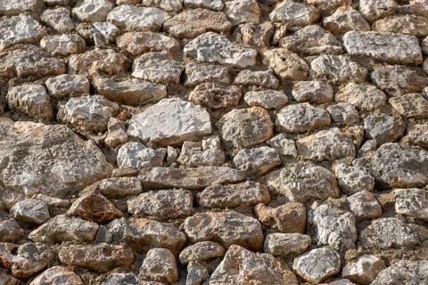 Texture of a stone wall. Old castle stone wall texture background. Stock Photos