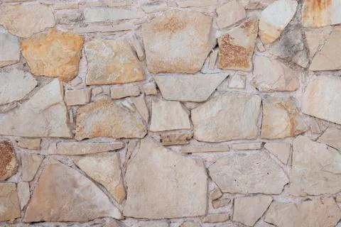 Texture of a stone wall. Old stone wall texture background. Stone wall as a b Stock Photos