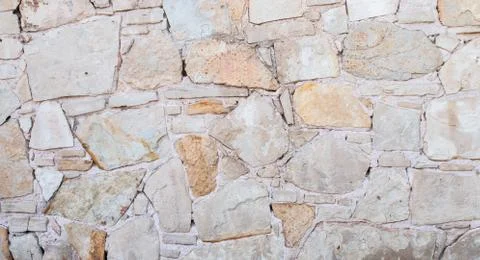 Texture of a stone wall. Old stone wall texture background. Stone wall as a b Stock Photos