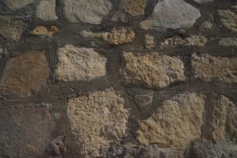Texture of a stone wall. Old stone wall background. Stock Photos