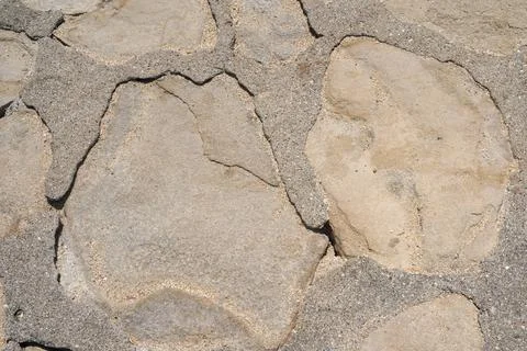Texture of a stone wall. Old stone wall background. Stock Photos
