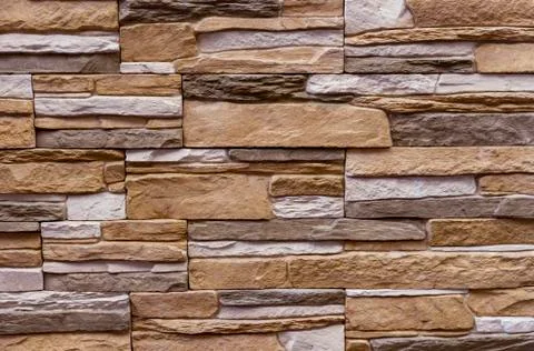 Texture of the stone wall. Panel of stones for finishing the facade. Stock Photos