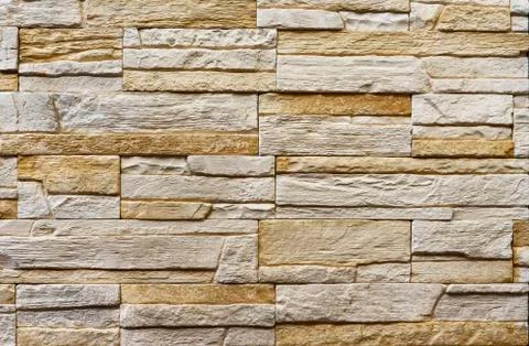 Texture of the stone wall. Panel of stones for finishing the facade. Stock Photos