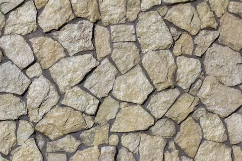 The texture of a stone wall. A stone wall as a background or texture. Stock Photos