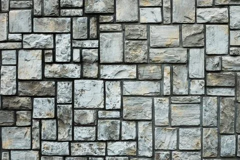 Texture of a stone wall. Stone wall as a background or texture. Part of a sto Stock Photos