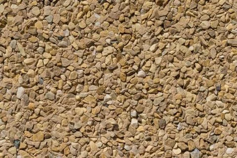 Texture stone wall wallcovering small pieces different stones Foto stock
