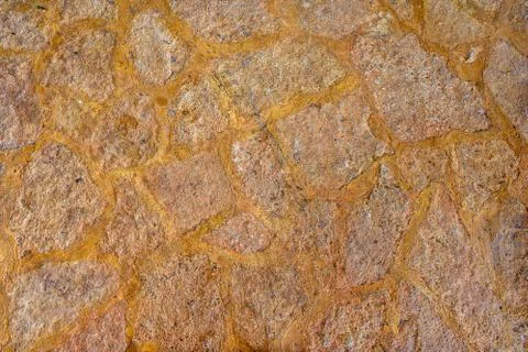 Texture stone yellow-colored clay, paving slabs yellow closeup. Stock Photos
