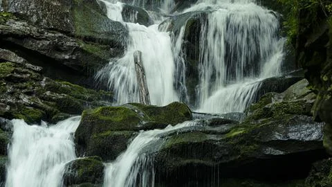 Texture of a stream of water falling down a waterfall Stock Photos