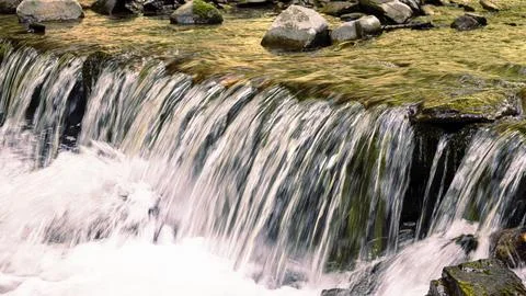 Texture of a stream of water falling down a waterfall Stock Photos